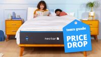 Two people lie on a Nectar Memory Foam mattress in a bedroom, a Tom's Guide price drop deals graphic is in the corner (right)